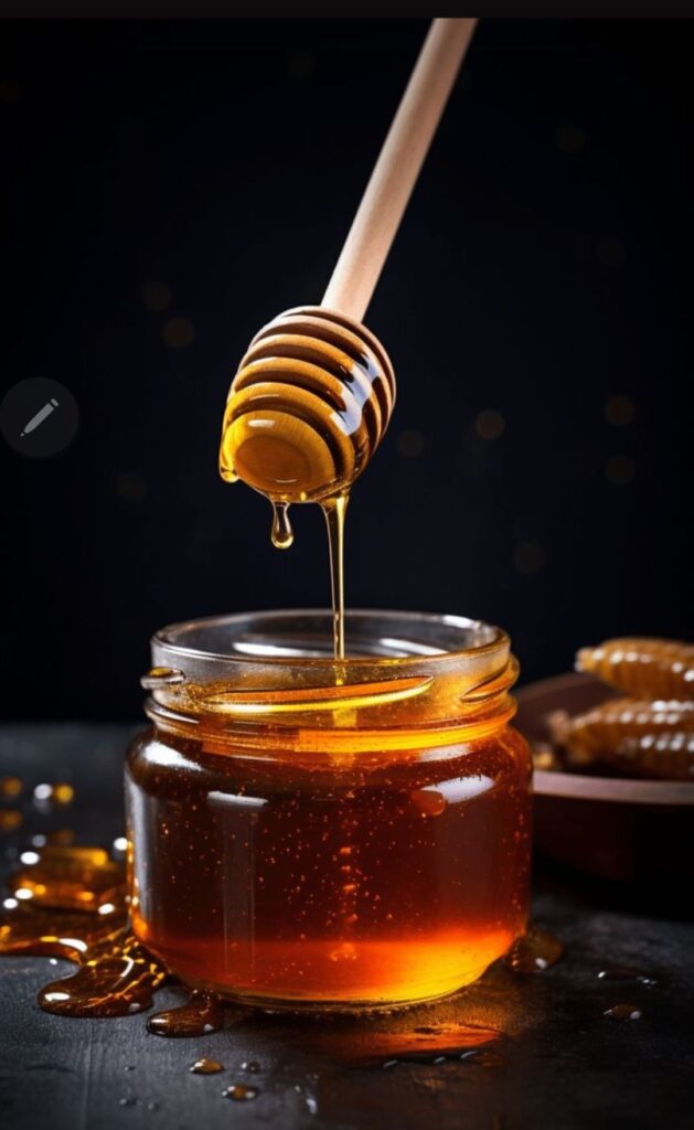 Jar of honey and wooden dipper